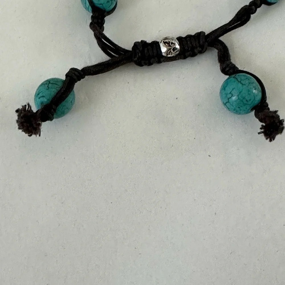 Turquoise beaded bracelet strung with waxed cord with crystal accent bead